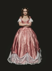 Beautiful woman in medieval dress on black background