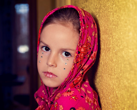 Little Girl Wrapped In A Shawl And With Dramatic Make-up