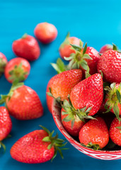 bowl of fresh strawberries on a wooden table