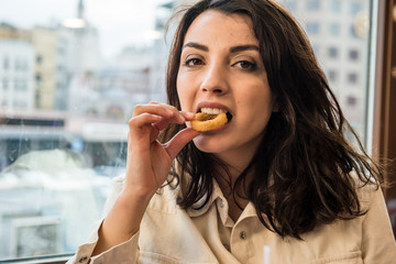 Cute girl sits a cafe with fast food