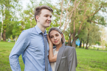 Fototapeta premium Romantic vacation. Young woman and man in park