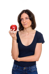 Studio shot of beautiful woman holding apple isolated against white background