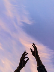 silhouette of hands against the sky