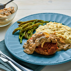 Meat Burger with Mushroom Gravy, Smashed Potatoes and Green Beans on Wooden table. Top view, directly above.