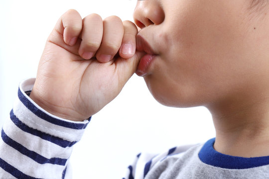 little boy sucking thumb isolated on white background