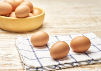 Organic chicken eggson a on a kitchen table, selective focus.