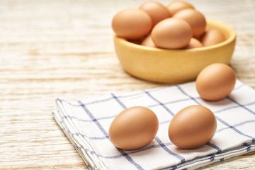Сhicken eggs  on a white wooden table, selective focus.