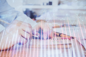 Multi exposure closeup hands with stock market forex graph.