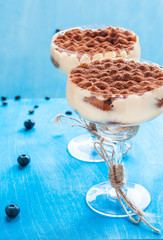 tiramisu dessert in a cocktail glass decorated with cocoa