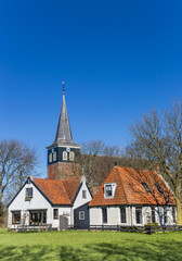 Fototapeta na wymiar Historic church and white houses in Makkum, Netherlands