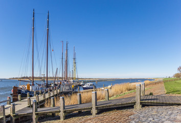 Fototapeta premium Sailing ships at the jetty in historic village Makkum, Netherlands
