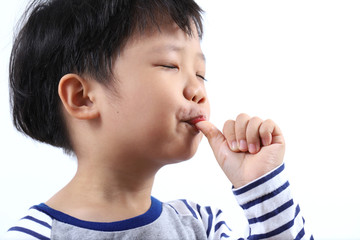 little boy sucking thumb isolated on white background