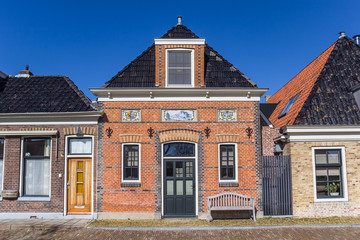 Historic red brick house in the Frisian village Makkum, Netherlands