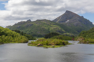 Beautiful view of the Norwegian fjords with turquoise water surrounded by cloudy sky, selective focus