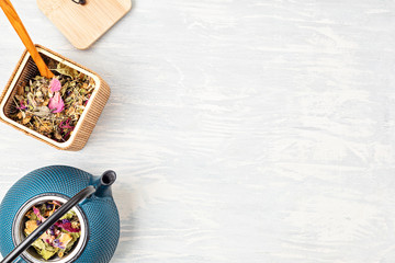 Traditional tea ceremony setup, teapot and teacup with herbs and dry fruits tea. Tisane detox,...