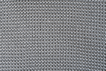Texture of gray woolen fabric in macro shot of repeating elements