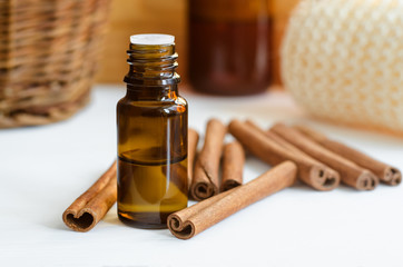 Small bottle with cinnamon essential oil. Aromatherapy, spa and herbal medicine concept. Copy space