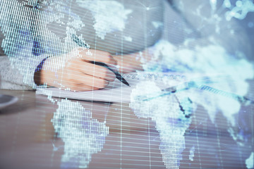 International business hologram over woman's hands taking notes background. Concept of success. Double exposure