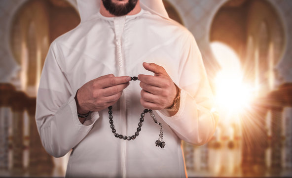 Arab muslim man praying for Allah, Muslim God , on mosque in ramadan kareem evening time  in sunset time.