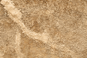 Natural natural texture of a stone slab with beige color plaster in macro shot