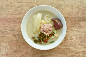 spicy boiled chicken meat and blood with slice cabbage in coconut milk soup on bowl