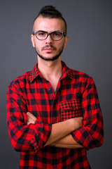 Handsome bearded Turkish hipster man with arms crossed