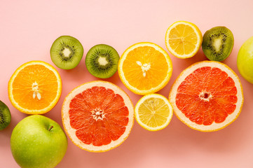 Fruits rich in vitamin C on a pink background