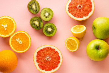 Fruits rich in vitamin C on a pink background