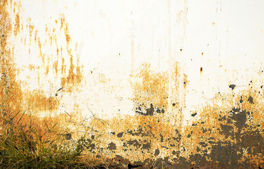 White metal door or wall close-up. Bright spots on a light background. Yellow, black and orange rusty spots on iron. Abstract urban background. Copy space. Selective focus image.