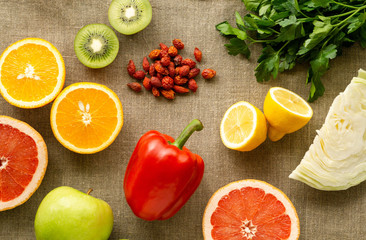 Various foods rich in vitamin C on a textile background