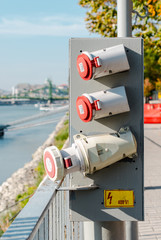 Three high voltage power outlets for boats next to the Danube in Budapest.