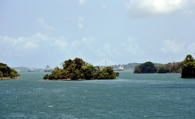 Green landscape of Panama Canal, view from the transiting cargo ship.