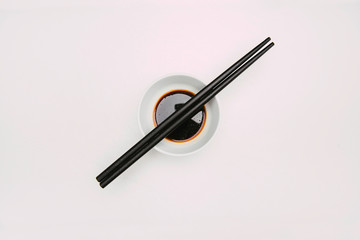 Stock photo of soy bowl with chopsticks on top and white background