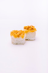 Stock photo of two rice maki with dried onion on top on white background.