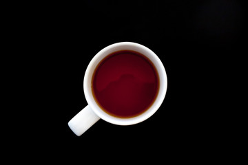 Cup of tea on black table, top view