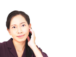 Asian business woman has dark brown long hair,  wear violet official shirt, her hand touch chin, show beauty face or listen something, copy space white isolate background. Lady is look at camera.