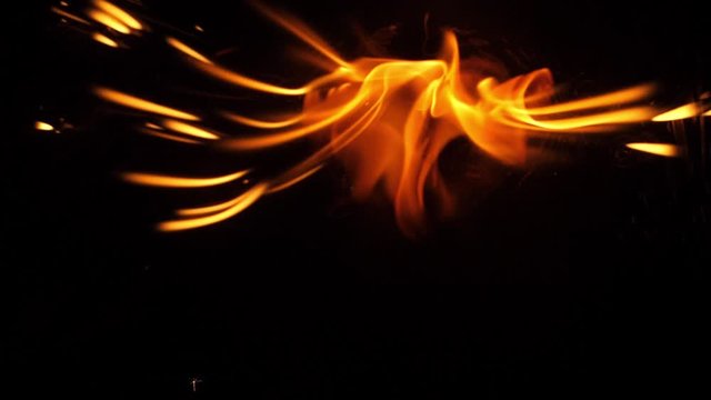 Slow motion speed close up scene on burning matchstick dropping on grunge floor that soak with oil, fast spread of hot flame above fuel surface, blasting stream pattern of fire ignite on petroleum