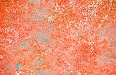 Wall with peeling plaster, tinted in pink. Modern urban building concept. Bright neon backdrop. Selective focus