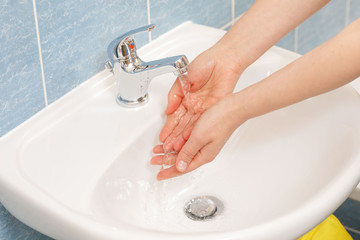 Hygiene concept. Washing hands with soap under the faucet with water