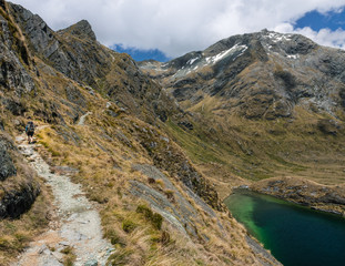 hiking past a lake in the mountains