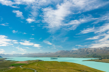 landscape at turquoise lake tekapo with blue sky and clouds