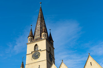 Church tower against blue sky