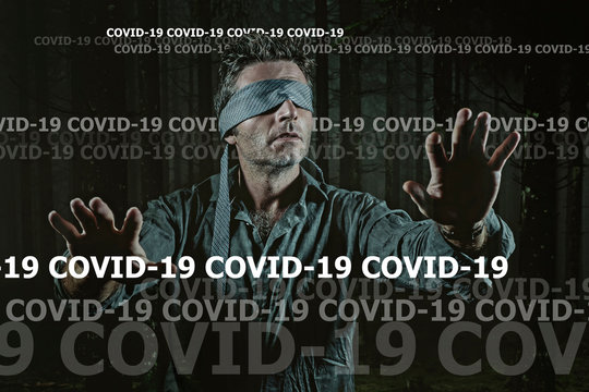 covid-19 virus outbreak concept on young scared blindfolded man lost in the dark and confused on the load of fake news and information about coronavirus pandemic