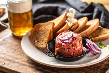 Beef tartare with red onion toast bread garlic and draft beer