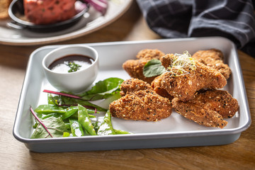 Fried chicken wings with sugar peas and herbs