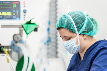 Covid-19 outbreak. Healthcare worker. Nurse working in intensive care unit. Mechanical ventilation...