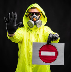 Man in protective respirator and gloves gesturing stop, warning of coronavirus epidemic, infection,...