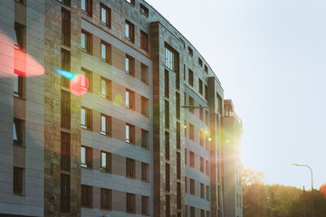 Modern apartment building exterior sunflare