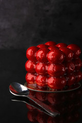 cake molecule, with strawberry icing, on a dark background