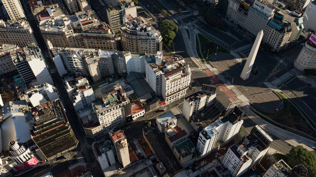 Aerial top view on iconic Obelisk and surroundings in Buenos Aires, Argentina during golden hour (sunset time) with no people or traffic due to corona virus quarantine - 24 March 2020